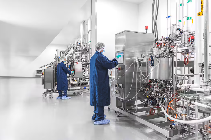 Technicians working with calibrated instruments in a pharma facility
